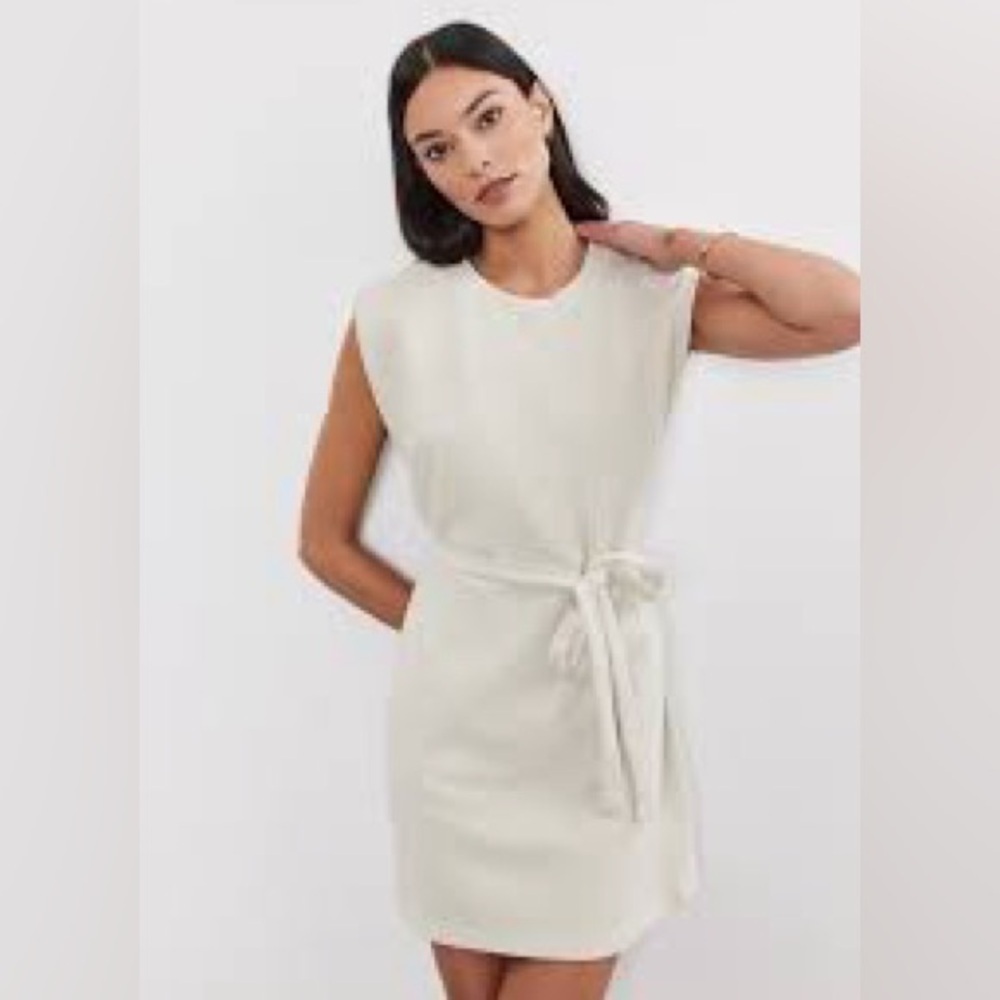 NWT boutique cream dress with tie and puffy shoulder.